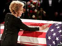 Nancy Reagan places her hand on her husband's coffin as it lies in the Capitol, 9 June 2004