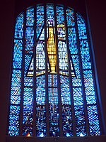 The principal window of the Temple of Maipú, Chile, depicting the Virgin Mary and Christ Child, by Adolfo Winternitz, showing the traditional use of blue as the predominant colour, emphasising an association with Heaven and creating an ambience in the interior.