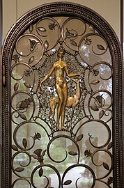 The foliage scroll – Elevator doors, by Brandt (1926), wrought iron, glass, patinated and gilded bronze, Calouste Gulbenkian Museum, Lisbon[117]