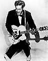Image 28The 1950s were the true birth of the rock and roll music genre, led by figures such as Chuck Berry (pictured), Elvis Presley, Buddy Holly, Jerry Lee Lewis and others. (from 1950s)