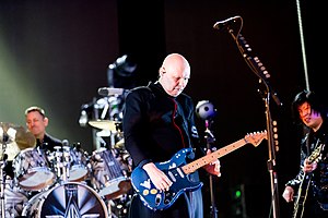 The Smashing Pumpkins performing in 2019. Left to right: Jimmy Chamberlin, Billy Corgan, and James Iha