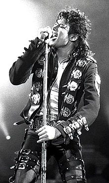 A photograph of Michael Jackson singing into a microphone