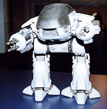 A photograph of a miniature ED-209 model