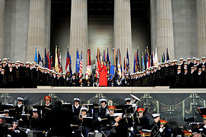 Fleming surrounded by a large military band, singing