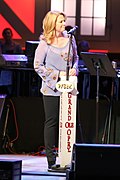 Singer Patty Loveless singing into a microphone.