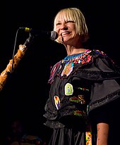 Sia singing to a microphone