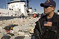 A Coast Guardsman stands guard over more than 40,000 pounds of cocaine worth an estimated $500 million being offloaded from the Cutter Sherman, 23 April 2007.