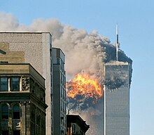 The[പ്രവർത്തിക്കാത്ത കണ്ണി] twin towers are seen spewing black smoke and flames, particularly from the left of the two.