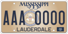 Mississippi current standard plate design (as of 2021). "IN GOD WE TRUST" can be seen at the bottom of the state seal, which is located in the gap between three letters and four numbers of the license plate.