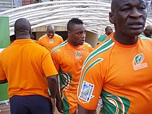 A close-up shot of the Ivory Coast players, in their country's orange jerseys, entering the field from the dressing room tunnel