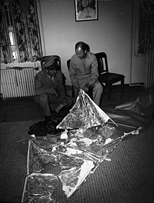 Ramey and Dubose with torn foil and sticks on packing paper
