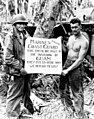 Marine Corps Privates First Class William A. McCoy and Ralph L. Plunkett holding a sign thanking the Coast Guard after the Battle of Guam in 1944[65]