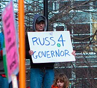 Man holding sign reading "Russ 4 Governor"