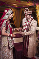 A Hindu North Indian wedding, the groom wearing a sherwani and pagri turban and the bride wearing a sari