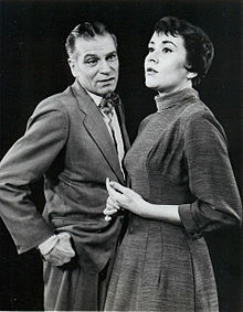 middle-aged man with young woman on stage