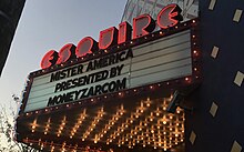 A film marquee reading "MISTER AMERICA / PRESENTED BY / MONEYZAP.COM