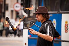 Street performer using a fire devilstick in São Paulo, Brazil