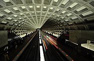 Train arriving at the McPherson Square metro station with a domed concrete ceiling