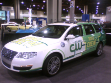 A green and white vehicle inside a convention center with the words "Atlanta CW Road Crew" emblazoned on the side