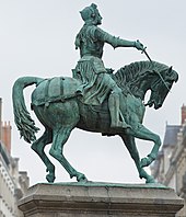 Joan of Arc on horseback, with sword in right hand