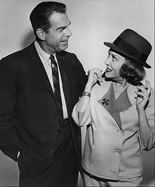 Black and white photo of a man and woman looking at each other