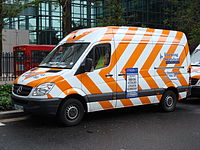 The Evening Standard has a fleet of delivery vans painted in a distinctive orange and white livery.