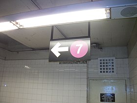 Directional sign above the staircase to the Flushing Line platform