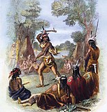 The indigenous war chief Pontiac stands in a circle of other indigenous people while brandishing a war hatchet above his head. There are trees in the background as well as what seems to be a teepee or tent. Some men in the circle also have weapons and all but one are sitting on the ground.