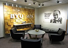 Lobby with writing on left wall, photograph on right wall