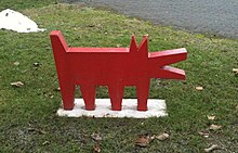 A simple statue of a red dog