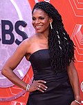 Audra McDonald in a black dress against a white background
