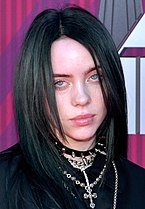 A picture of Billie Eilish smiling towards the camera