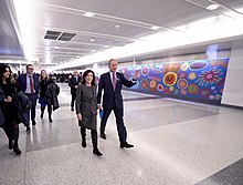 Politicians walking through the new bright LIRR concourse