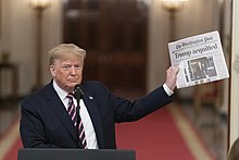 Trump displaying the front page of The Washington Post reporting his acquittal by the Senate