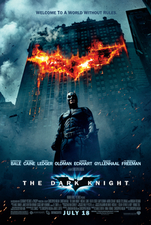 In the background, a building burns in the outline of a bat symbol. In front of the building, Batman looms. Above reads the tagline: "Welcome to a world without rules." Below is the film's logo and the credits.