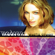 Madonna looking towards the camera in front of a blue background. The lower half of the cover art shows the artist and song name in front of a violet flowery background.