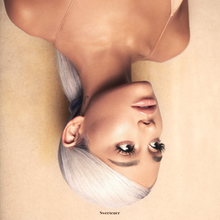 A portrait of Ariana Grande, shown upside down. Looking to the right side of the image, she wears a sleeveless shirt, a white wig, and a nude lipstick, the latter of which matching the color of the background and the shirt. At the bottom of the cover art, small text that reads "Sweetener" is displayed in black.