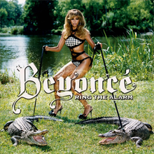 A brunette woman is standing near a swamp. She wears a two-piece bikini with black-and-white squares as its pattern. With her hands, she grabs straps that hold crocodiles. In the center, the word "Beyoncé" and "Ring the Alarm" are written in a white font.