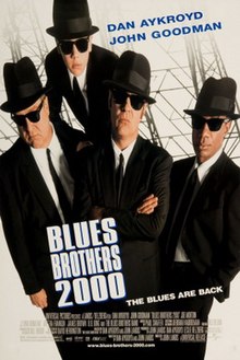 The cast members in black suits and sunglasses