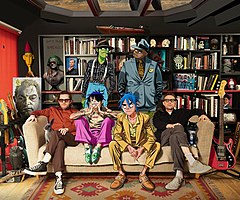 Gorillaz in 2020. Jamie Hewlett (left) and Damon Albarn (right) with animated members Murdoc Niccals, Russell Hobbs, 2-D, and Noodle.