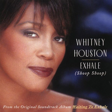 The face of a woman smiling. She has a brunette hair and is wearing dark-colored lip color. To the right of the image, the words "Whitney Houston" are printed, below which are the words "Exhale" and "Shoop Shoop".