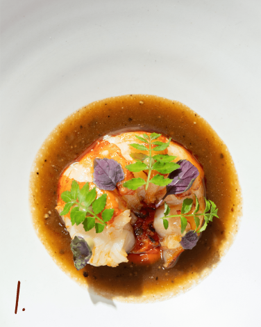 #1: Lobster dish plated with leaves and sauce
