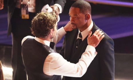 Bradley Cooper talks to Will Smith at the 94th Oscars.