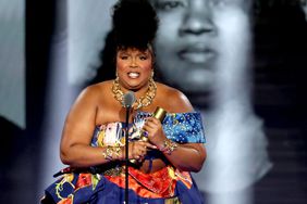 SANTA MONICA, CALIFORNIA - DECEMBER 06: 2022 PEOPLE'S CHOICE AWARDS -- Pictured: Honoree Lizzo accepts The People's Champion award on stage during the 2022 People's Choice Awards held at the Barker Hangar on December 6, 2022 in Santa Monica, California. -- (Photo by Rich Polk/E! Entertainment/NBC via Getty Images)