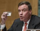 
	In this Monday, Feb. 3, 2014 photo, Sen. Mark Warner, D-Va., chairman of the Senate Banking Subcommittee on National Security and International Trade and Finance, displays his personal bank card as he leads a hearing on the recent incidents of mass credit card fraud in Washington. The hearing comes following the theft of consumers’ data at retailers such as Target Corp and Neiman Marcus during the holiday shopping season. (AP Photo/J. Scott Applewhite)
