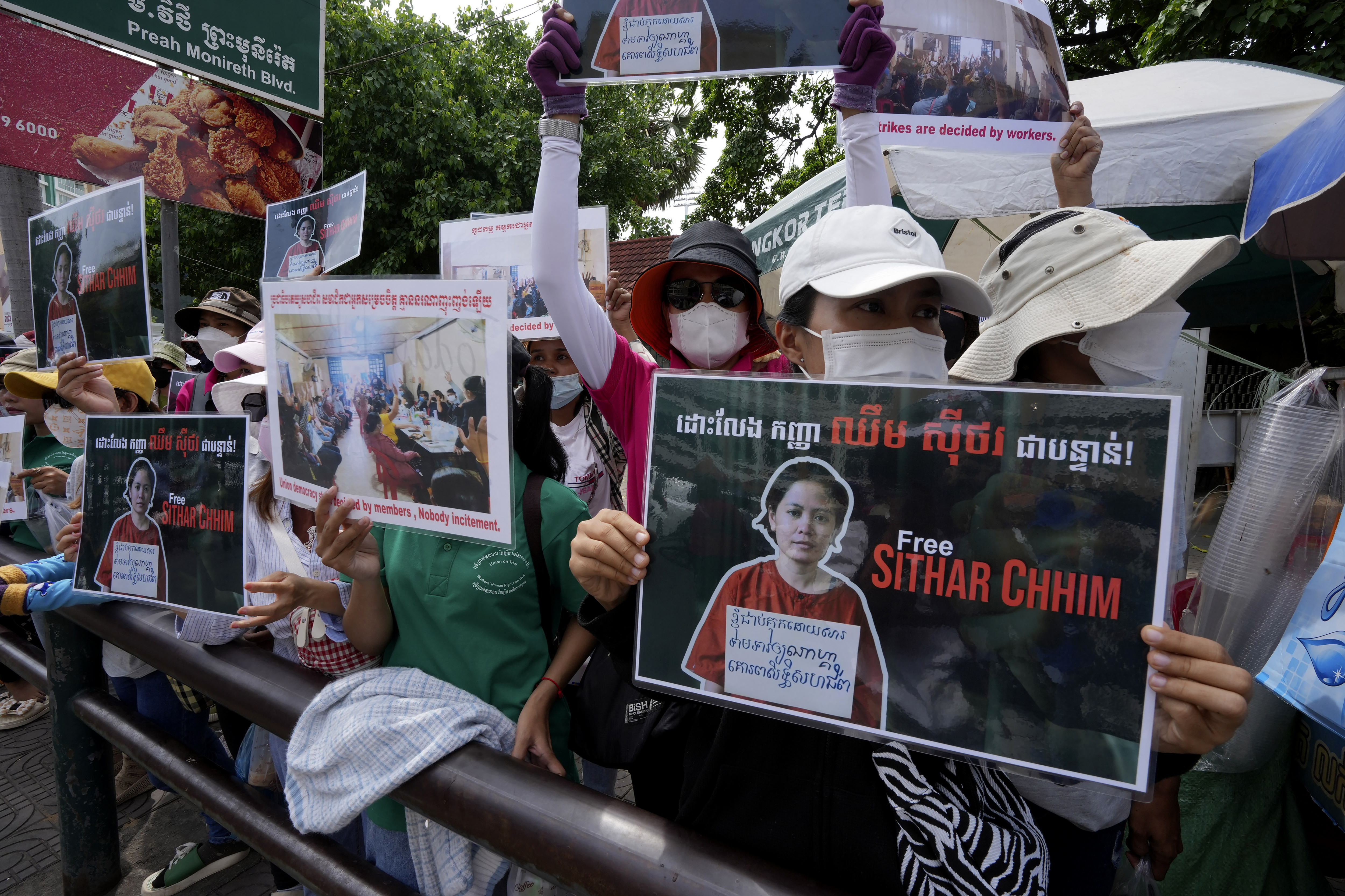 FILE - Supporters hold a portrait of NagaWorld's union leader Chhim Sithar during a protest in front of Phnom Penh Municipal Court in Phnom Penh, Cambodia, on May 25, 2023. Cambodia’s Supreme Court on Friday May 3, 2024 upheld the two-year prison sentence of a labor union leader who led a long-running strike against the country’s biggest casino. Chhim Sithar, president of the Labor Rights Supported Union of Khmer Employees of NagaWorld, had originally been convicted in May 2023 of incitement to commit a felony. (AP Photo/Heng Sinith, File)