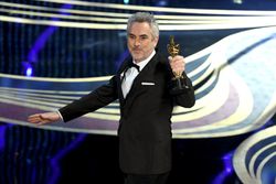 Filmmaker Alfonso Cuaron accepting the Academy Award for Best Cinematography
