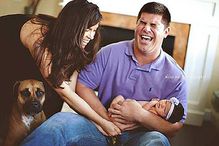 married couple with pooping baby and dog