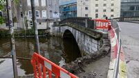 Two hospitalised and section of historic Cork City bridge knocked into river after crash